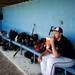 Milan High School junior James Carpenter sits in the dugout by himself before the game against Richmond in Battle Creek on Friday, June 14. Daniel Brenner I AnnArbor.com